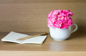 Wall Mural - Fresh pink carnation flower with note book and pencil 