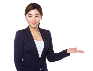 Wall Mural - Young businesswoman with hand showing blank sign