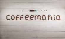 Syringe And Inscription Coffeemania Coffee Made From Coffee Bean