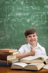 Wall Mural - Cute schoolboy showing thumbs up