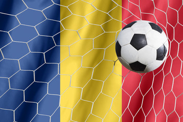 Romania waving flag and soccer ball in goal net