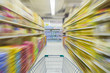 © FAMILY STOCK - motion blur of supermarket cart in supermarket