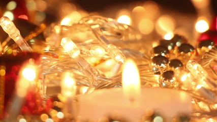 Wall Mural - candle and christmas lights close-up out of focus
