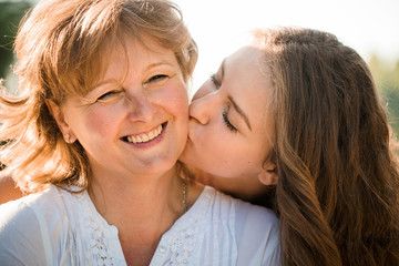 Wall Mural - Happy together - mother and teenage daughter outdoor