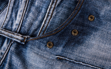 Poster - fashionable clothes. pile of jeans on a wooden background