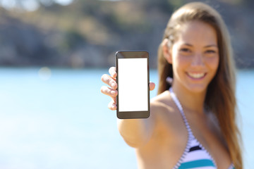 Canvas Print - Sunbather showing blank phone screen on the beach