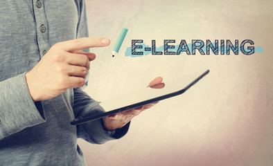 Sticker - Young man pointing at E-Leaning text over tablet computer