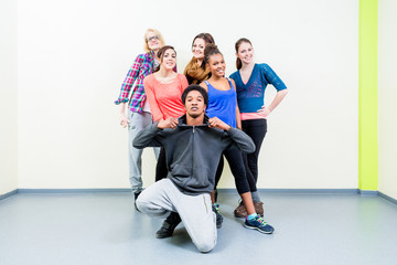 Young men and women in dance class posing