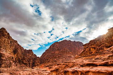 Wall Mural - Rocky mountain of Wadi Rum in southern Jordan 60 km to the east of Aqaba. Wadi Rum has led to its designation as a UNESCO World Heritage Site and is known as The Valley of the Moon.