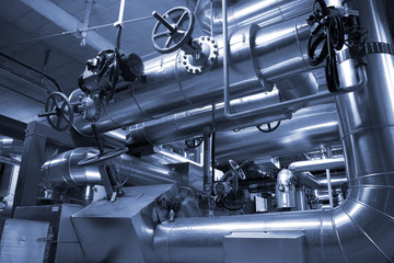 equipment, cables and piping as found inside of a modern industr