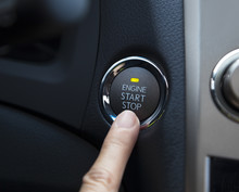 Finger Pressing The Engine Start Stop Button Of A Car