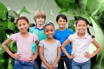 Canvas Print - Composite image of cute pupils smiling at camera in classroom