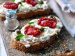 toast of rye bread with different seeds with ricotta cheese, sun-dried tomatoes, capers, parsley and olive oil.