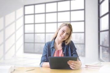 Wall Mural - Composite image of student studying in the library with tablet