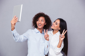 Sticker - Girls making selfie photo on tablet computer