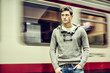 Handsome young man inside train station looking away