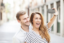 Portrait Of A Happy Couple Making Selfie Photo With Smartphone