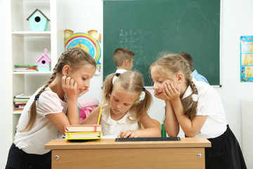 Wall Mural - Portrait of happy schoolgirls at lesson