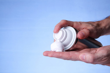 A man with shaving cream on his hand