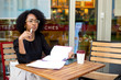 © michael spring - young woman looking thoughtful at the coffee shop