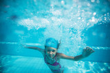 Fototapeta Łazienka - Child swims in pool underwater.
