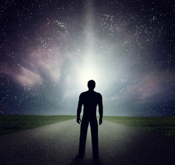 Wall Mural - Man standing on the road looking at stars, sky, universe. Dream, adventure.