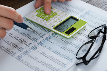 Person Hands Analyzing Accounting Document