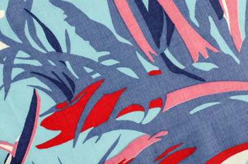 Abstract blue and red pattern on fabric. Asymmetric lines and shapes print as background.