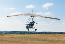 The Motorized Hang Glider Over The Ground