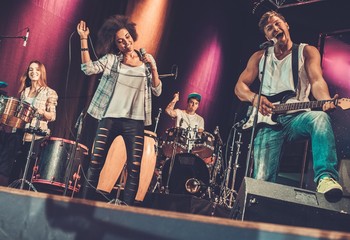 Wall Mural - Multiracial music band performing on a stage