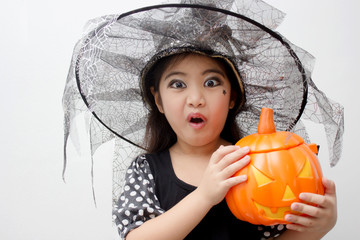 Portrait of cute girl in Halloween costume looking at camera