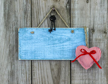 Blank Blue Sign With Keys And Heart Hanging On Rustic Wood Background
