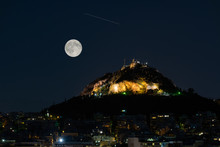 Lycabettus Mountain In Athens Greece Against The August Full Moon And A Falling Star.
