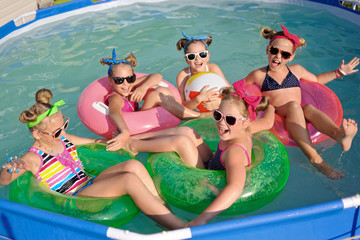 Wall Mural - Portrait of children on the pool in summer