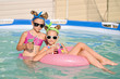 Portrait of two girls in a swimming pool