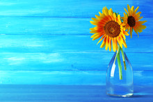 Beautiful Sunflowers In Vase On Wooden Background
