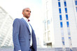 © zinkevych - Confident businessman standing near office building