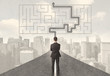 © ra2 studio - Businessman looking at road with maze and solution