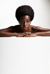 Wall Mural - funky style black woman with afra lying down on a white