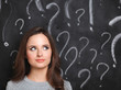 © shefkate - Young girl with question mark on a gray background