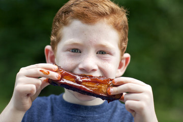 Boy eating rib