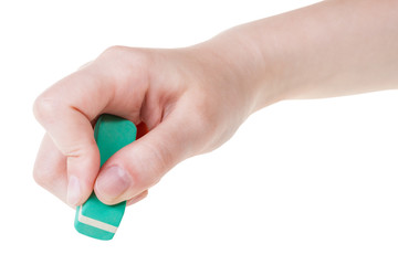 hand with green new rubber eraser close up