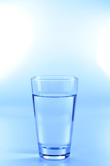 Wall Mural - Glass of water on light background