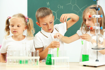 Wall Mural - Cute pupils doing biochemistry research in chemistry class