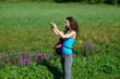 © cwzahner - Beautiful young woman take photos with her smartphone while hiking