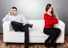Young Couple After Quarrel Sitting On Sofa