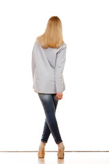 Wall Mural - woman in denim pants high gray shirt back view