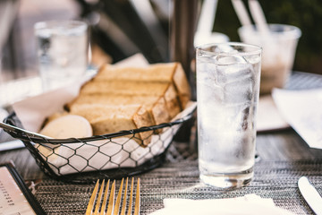 Bread and water on the table outdoors