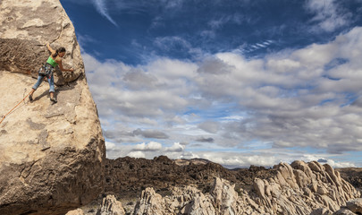 Wall Mural - Rock climber clinging to a cliff.