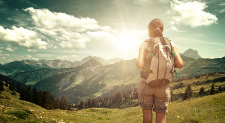 Wall Mural - hiker enjoying the view from mountain valley trail